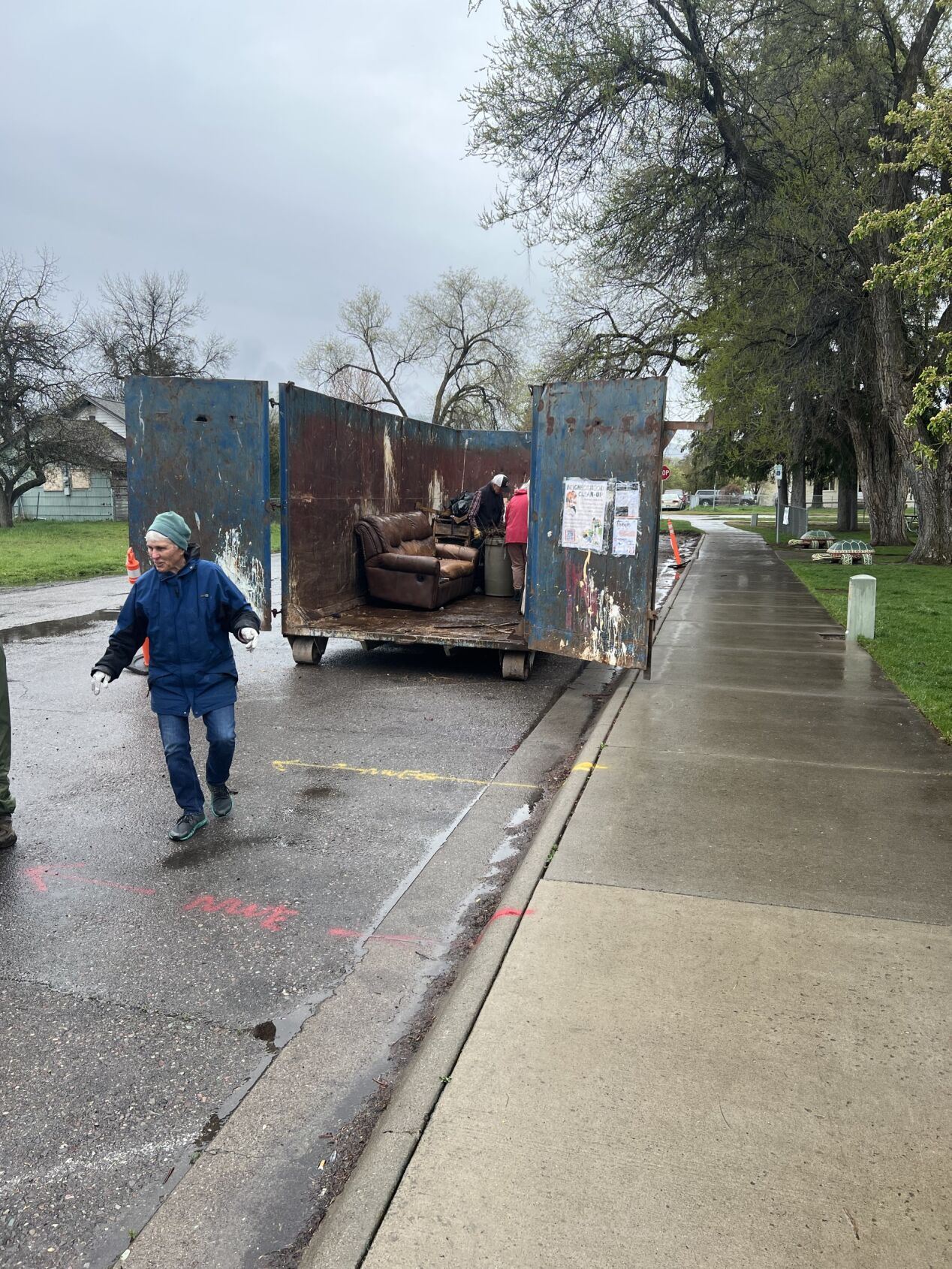 A dumpster on the side of the road 